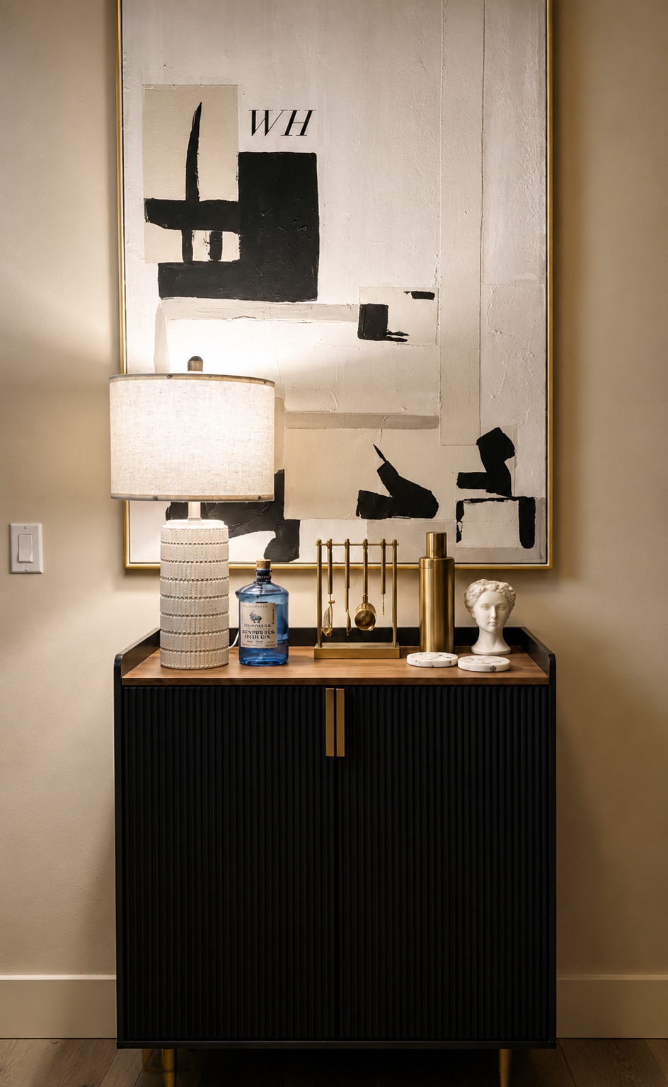 Styled black fluted cabinet beneath abstract artwork