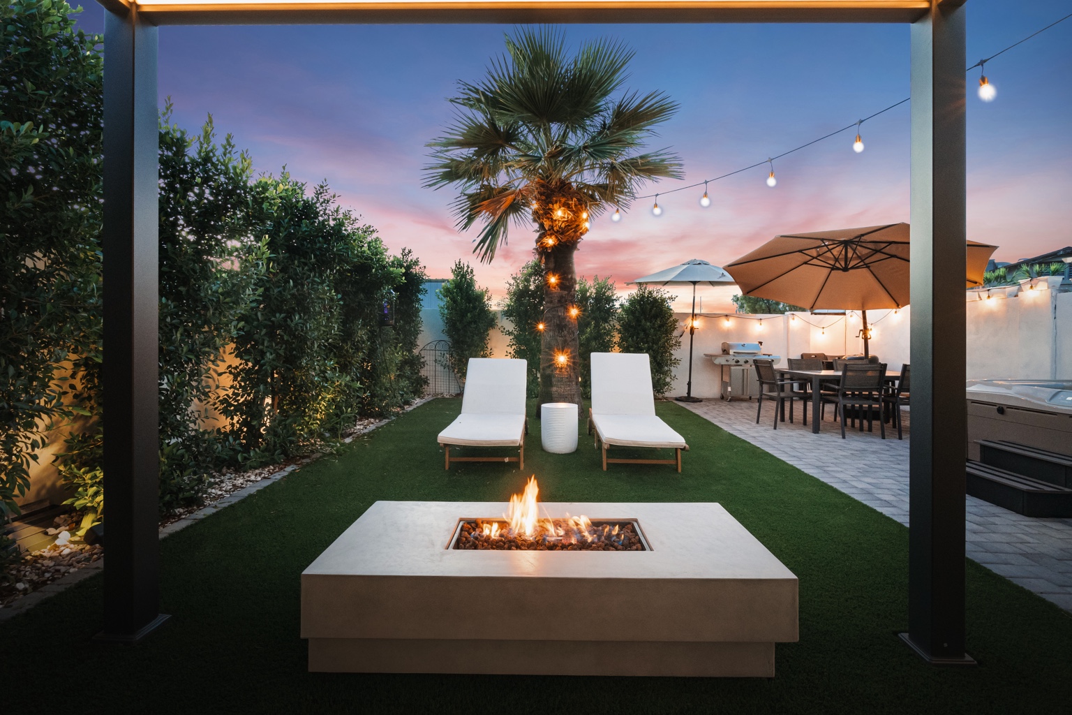 Landscaped courtyard with fire table and lounge seating