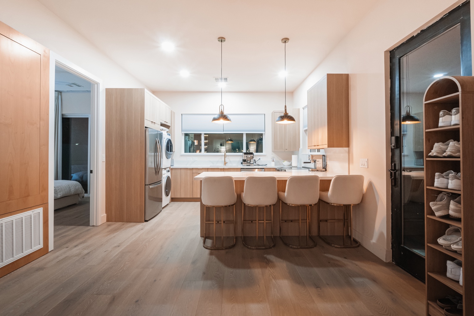 Light wood ADU kitchen with island and integrated laundry