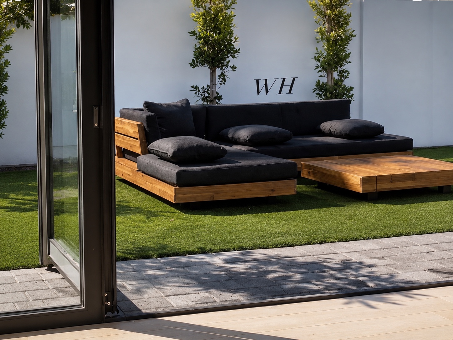 Custom outdoor sectional viewed through an open glass door